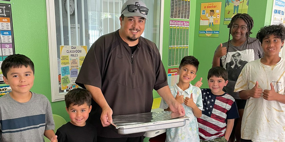 Mr. Greg delivers food to the children at the Sunset Heights after-school program