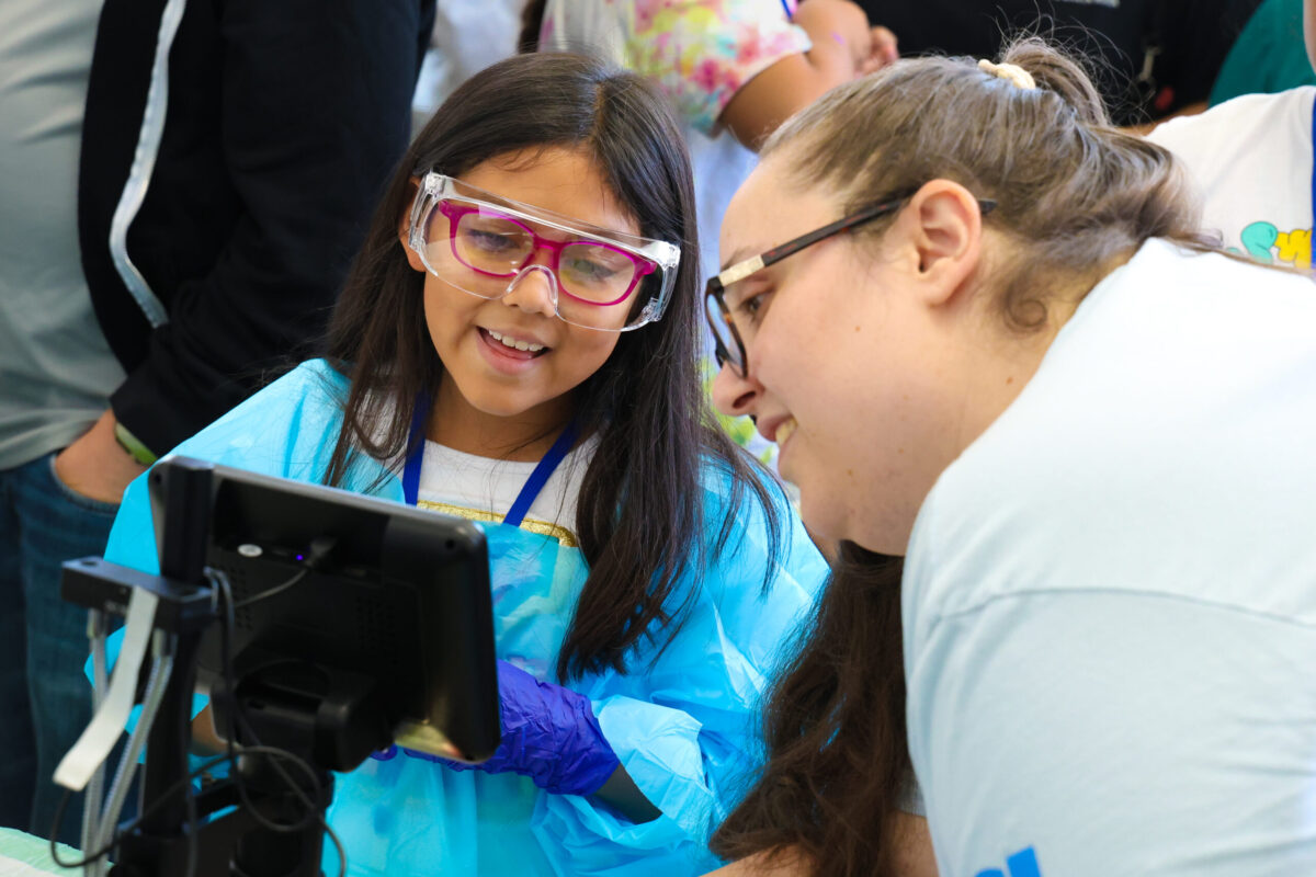 Children engage with life science through hands-on activities and learn from real scientists at the Hope through Housing fair.